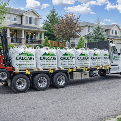 Bulk landscape bags filled with decorative rock and gravel for residential landscaping projects in Calgary