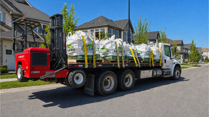 Calgary Landscape Bags bulk bag beside a residential garden finished with dark decorative rock